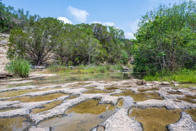 The trailhead provides access to serene waterfall vistas near Lake Austin.