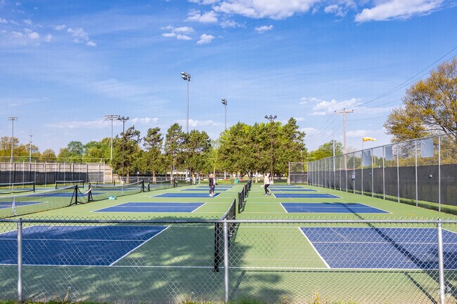 A group plays pickle ball at the Meador Park tennis courts.