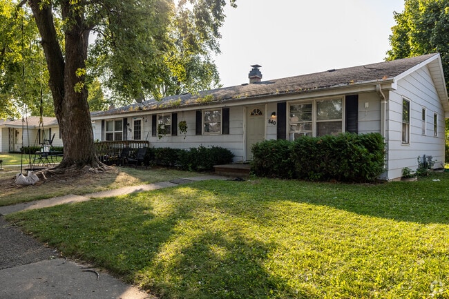 A larger ranch home sits beneath the shade of a mature tree in Imperial Pride.