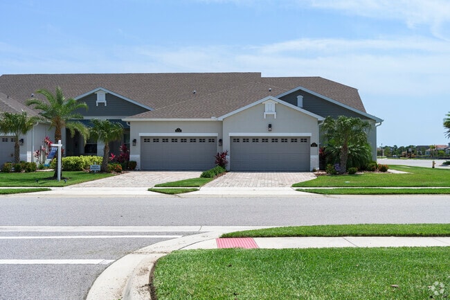 A row of Viera West townhomes has neatly manicured yards and strong curb appeal.