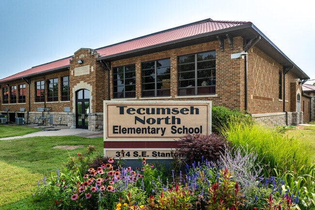 There is a sign for Tecumseh North Elementary School near the road.