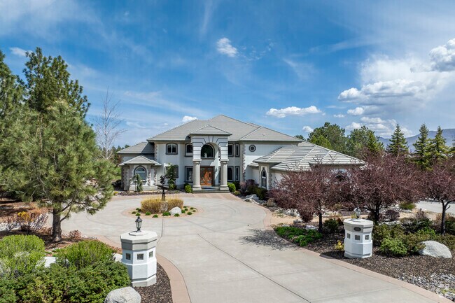 On the golf course in Franktown we have an elegant Mediterranean estate with grand columns, arched windows, and timeless luxury design.