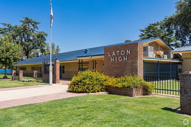 An American flag waves high above the entrance to Laton High School.