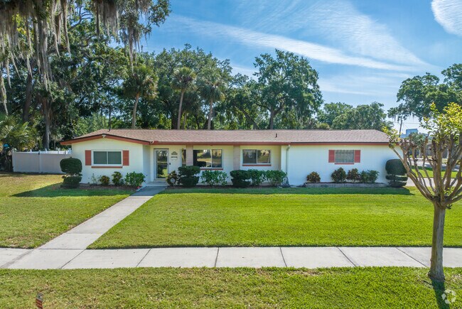 Older American Contemporary homes line the street surrounding Rock Lake