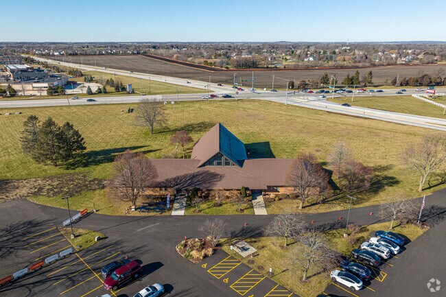 North Aurora Seventh-Day Adventist School is surrounded by a grassy field & large parking lot.