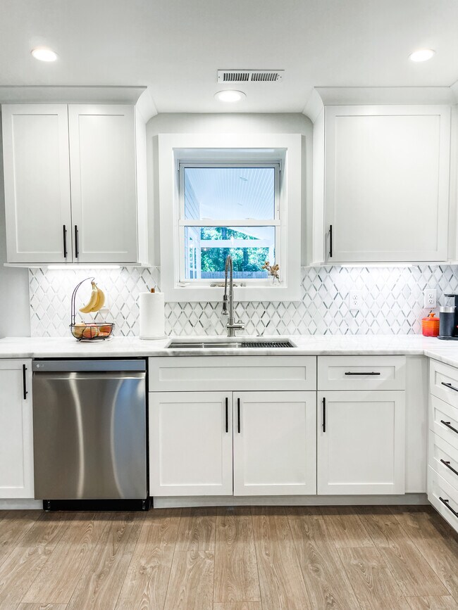 Deep single compartment sink with disposal and sprayer