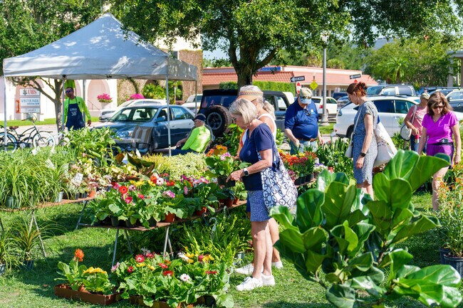A resident enjoys picking flowers for her garden at the Winter Park Farmer's Market.