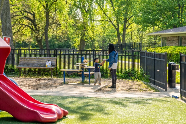 A young boy plays in the sand pit at Toohey Park.