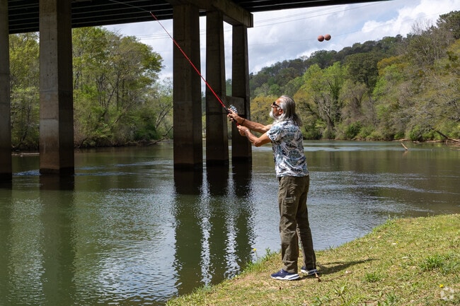 Man taking in some relaxing fishing along the Chattachoochee River near the neighorhood of Ellard.