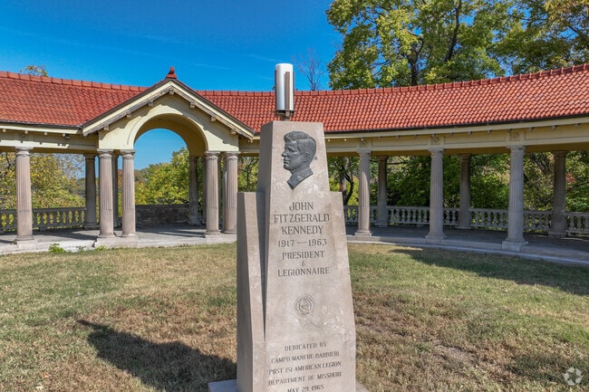 A memorial of John F. Kennedy stands in the center of The Concourse Park.