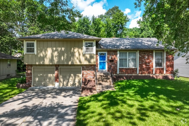 Split-level homes with brick and wood facades are shaded by large oaks in Willow Creek.