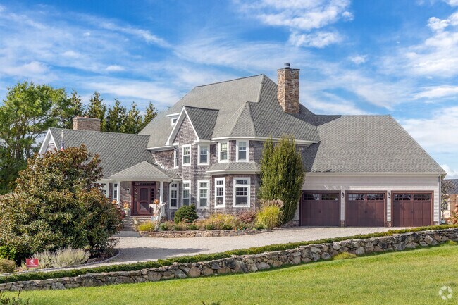 Vast modern homes sit atop hills overlooking the Westport River in South Westport.