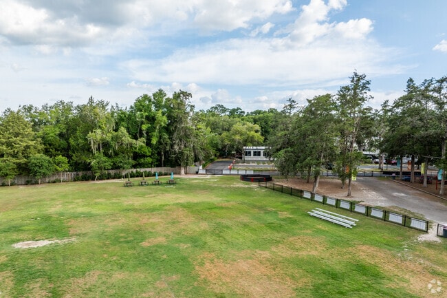 Students run in the open field at The Rock School.