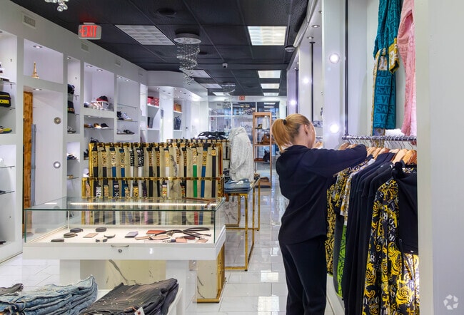 Residents shop for designer clothing at Enzo.
