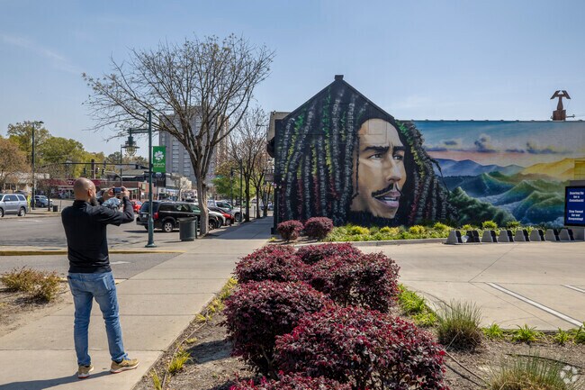Visitors to Five Points are often seen taking pictures of some of the several murals.