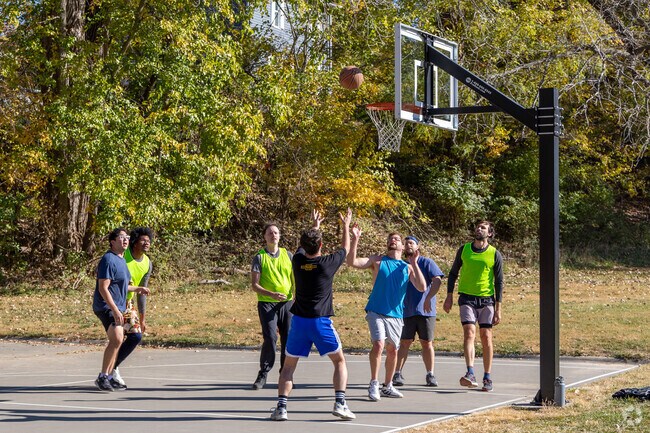 Goosetown residents enjoy a weekend game of basketball at Happy Hollow Park.