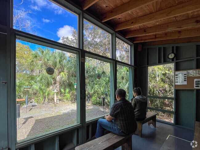 Bird watchers observe the feeders from the blind enclosure at Felts Audubon Preserve.