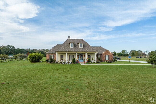 A home sits on a large lot along the outskirts of Scott, Louisiana.
