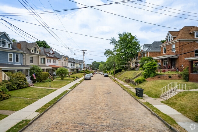 Some homes in Bellevue sit up on hills looking down on brick roads.