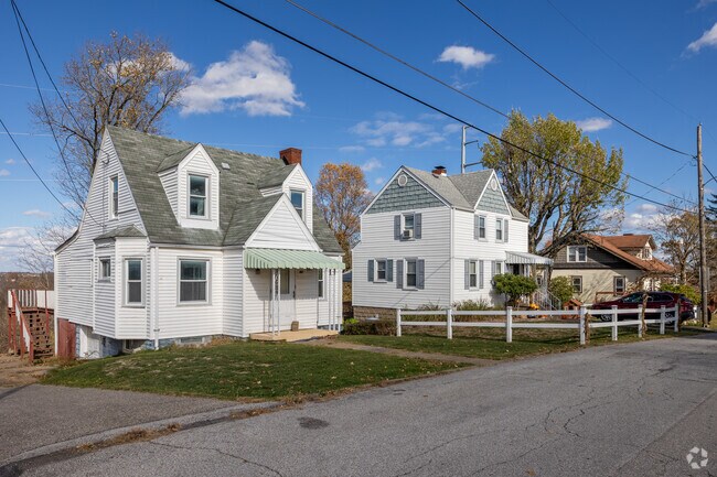 Mozart homes feature manicured lawns and hillside views.