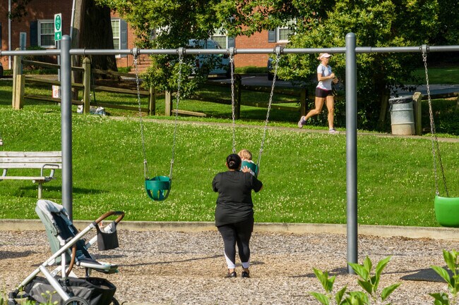 A mother pushes her child on a swing at Sedgefield Neighborhood Park.