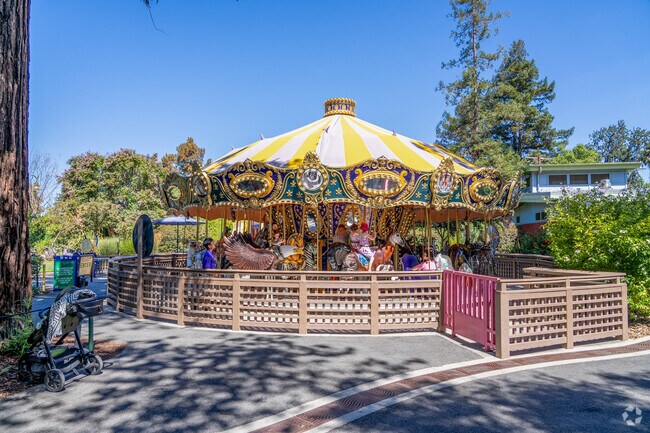 Kennedy children enjoy laughter and spins on Happy Hollow Zoo's classic carousel.