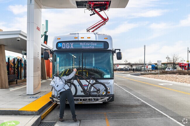 A UTA rider puts his bike on the rack before entering the bus in downtown Ogden.