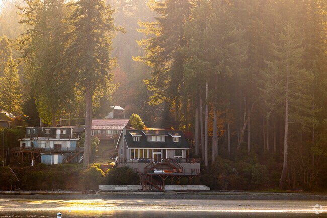 Beach homes sit along the coast of Home in the morning light.
