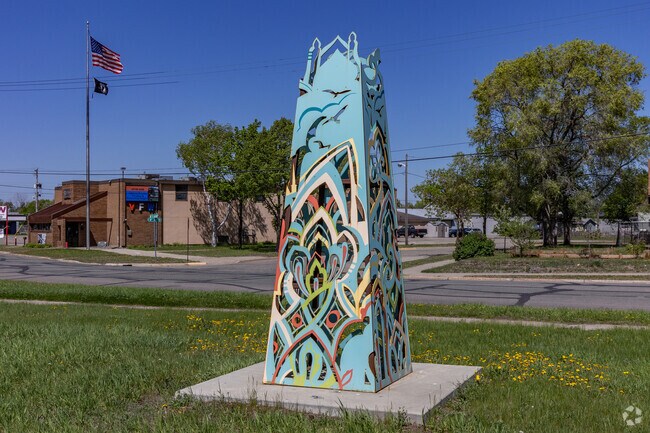 A colorful steel structure serves as the gateway to the Saint John Cantius neighborhood.