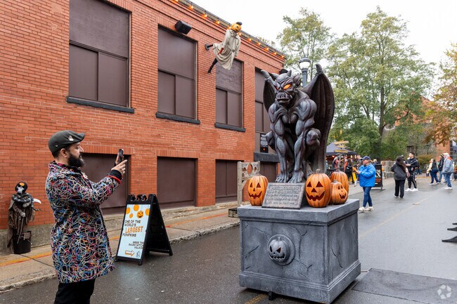 Halloween spirit comes alive in Salem, Massachusetts, as visitors snap photos with eerie decorations and festive displays in the city famous for its spooky season celebrations.