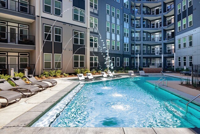 Resort Inspired Swimming Pool with Sunning Ledge and Deck Jets