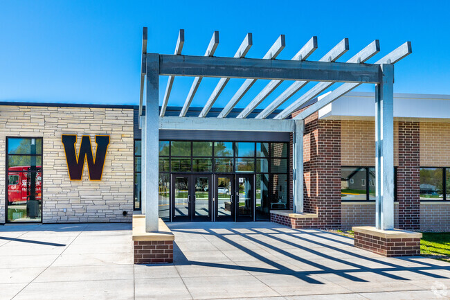 The modern main entrance of Winterset Junior High is inviting and secure.