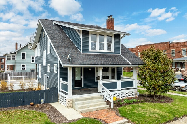 A Dutch Revival home in Weinland Park features a covered front porch.