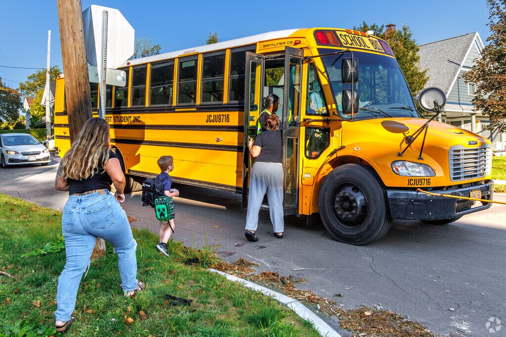 Syracuse children love to get on the bus for their first day of school to Porter Elementary.