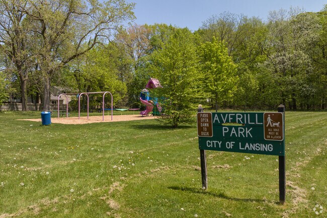 The Averill Park sign stands on Averill Drive in Averill Woods, Lansing, with the playground visible in the background.