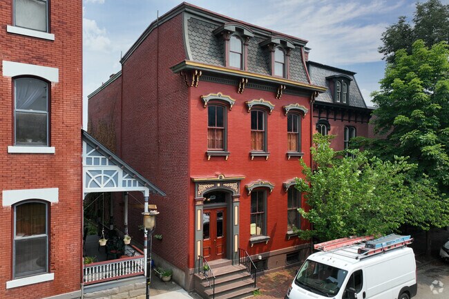 Italianate style home highlighting red brick facades, tall windows is found in Allegheny West.