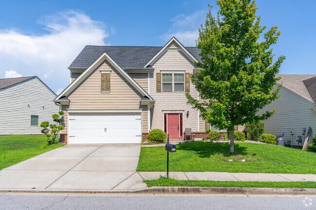 This new traditional has a flair of red for it's door in Mundy Mill.
