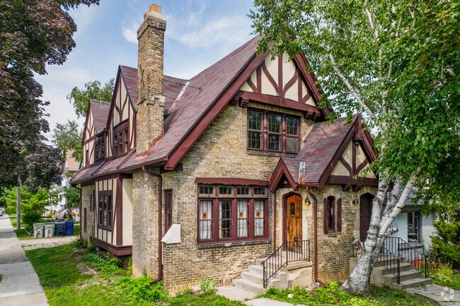 Tudor-style homes have sheer roofs and are covered by wood siding and brick.