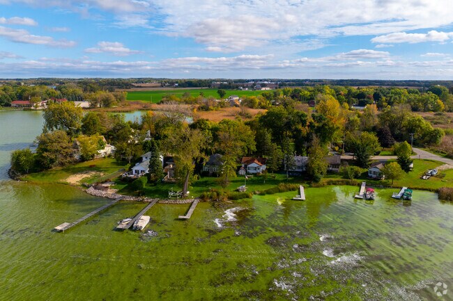Private docks extend from Eagle Lake homes into vivid green water.