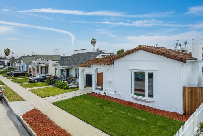 White Mediterranean-style home with tile roofing in Chesterfield Square.