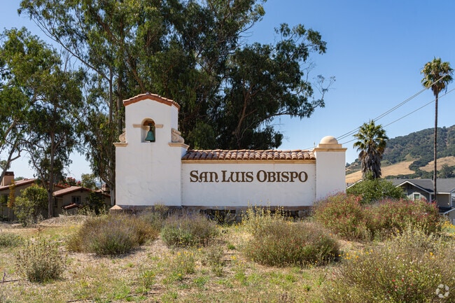 A large Spanish style inspired sign welcomes visitors along Highway 1 to Highland neighborhood.