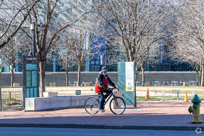Bike riders enjoy a trip around Triangle Park in Historic Western Suburb.