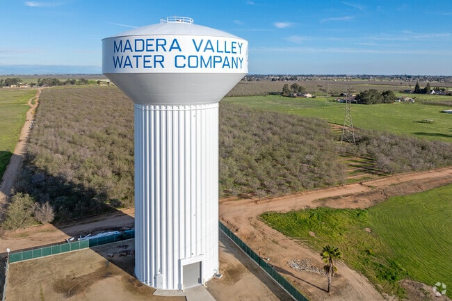 The Madera Valley Water Company water tower rises above the farmland of Madera Acres.