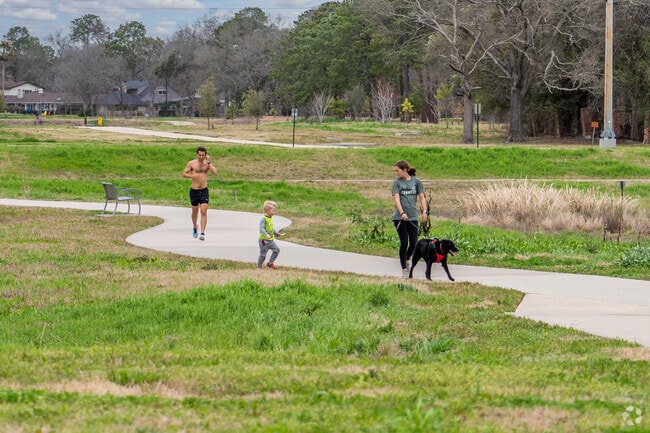 A family takes a walk along one of Webster's many walking trails.