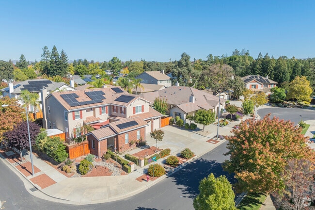 Many homes in Kristopher Ranch feature an extended parking area delineated by a small outbuilding.