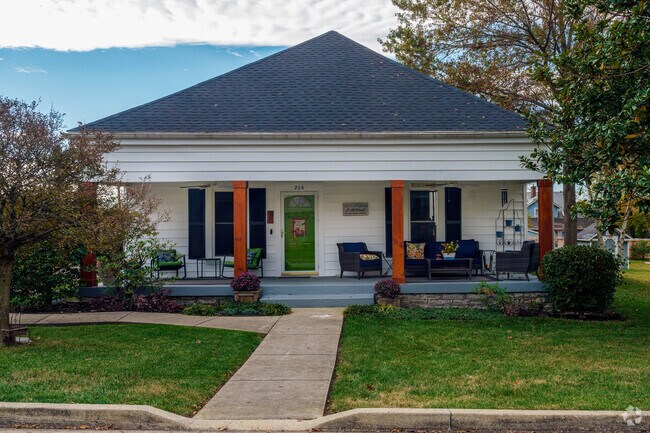 Wooden pillars and a vibrant green door set this home apart in Wilmore.