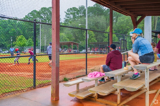 Families cheer proudly for youth baseball players during games at Medlock Park near Greater Valley Brook.