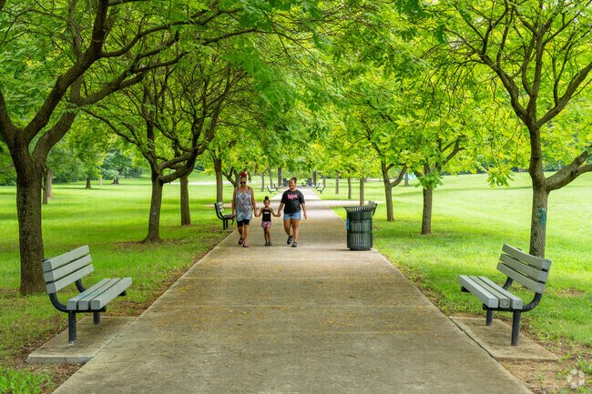 Melrose families walk through the tree-lined path from the playground at Brown-Robertson Park.