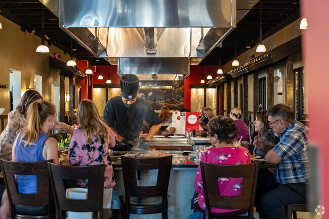 A chef prepares food right at his customers’ table.