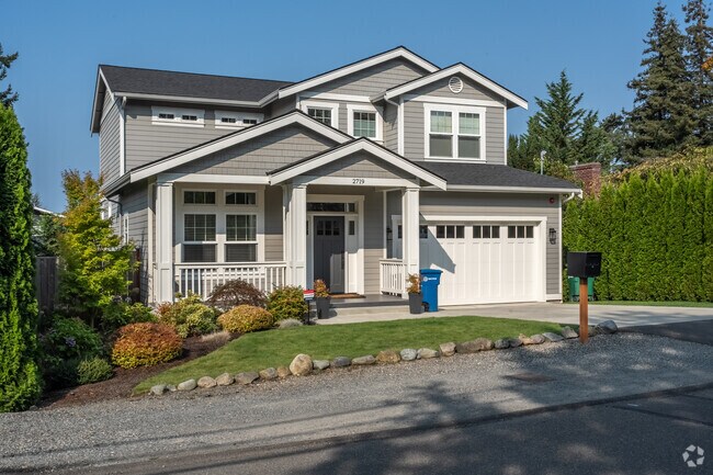 A modern craftsman in Mercer Island, with a manicured front yard and plenty of morning sun.